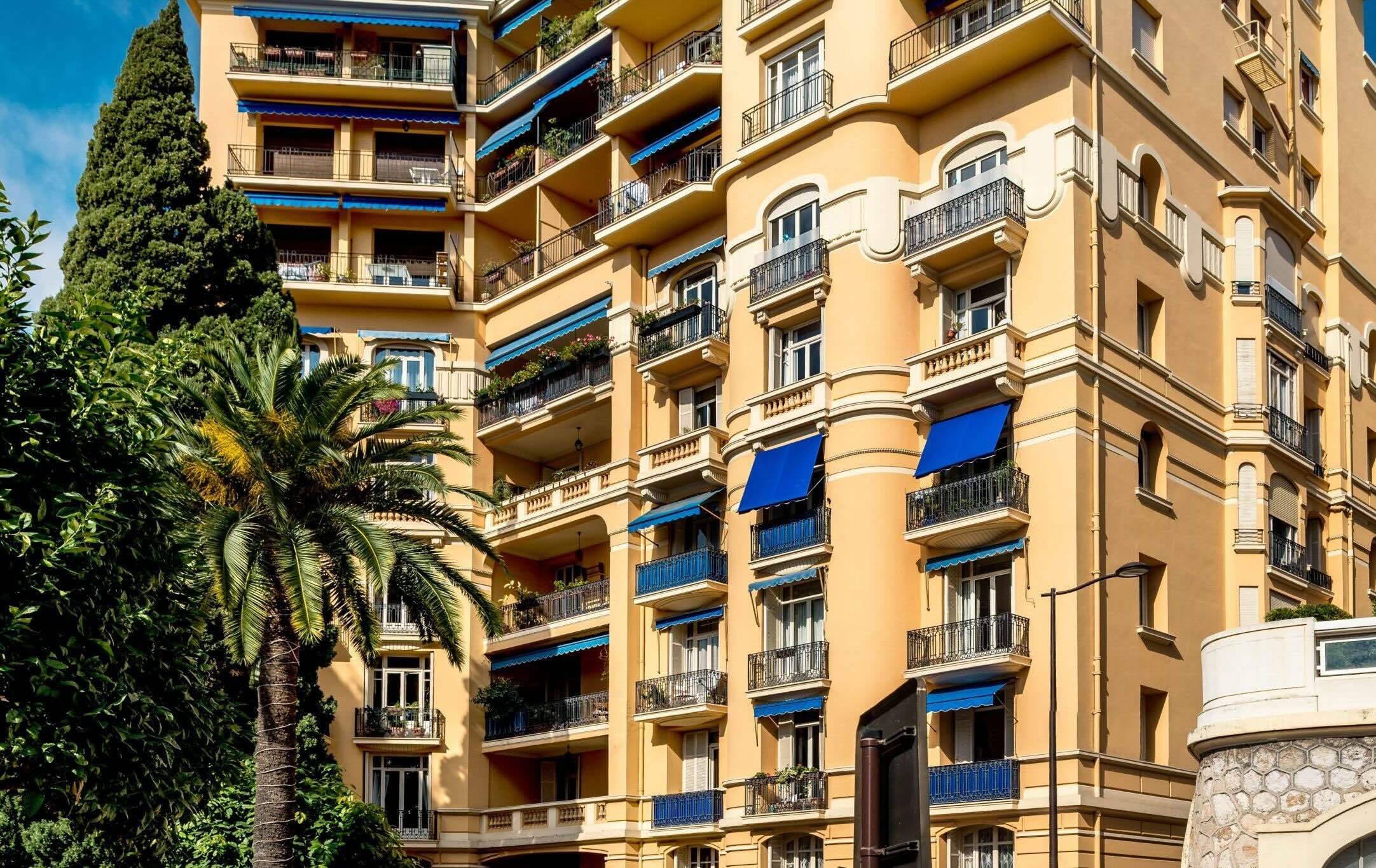 Architectural details of Palais du Printemps, Monaco, with classic facades and lush surroundings.